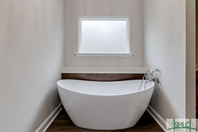 127 Winding Way Rd, Pembroke, GA 31321 - bathroom with a freestanding tub and wood finished floors