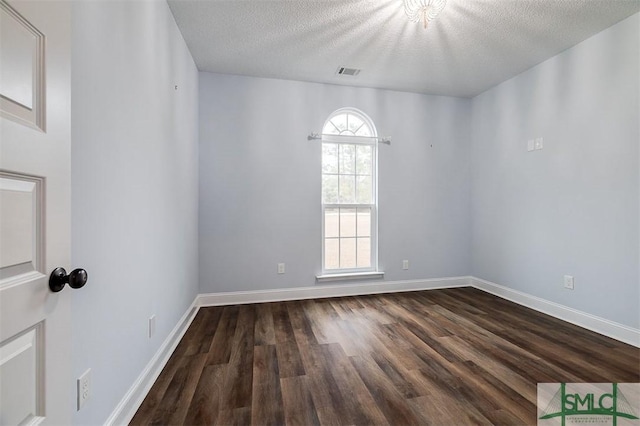 127 Winding Way Rd, Pembroke, GA 31321 - spare room with dark wood-style flooring and a textured ceiling