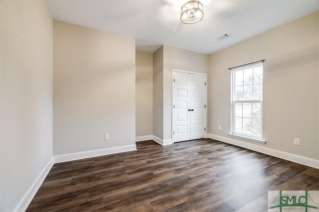 127 Winding Way Rd, Pembroke, GA 31321 - unfurnished bedroom featuring dark wood-type flooring and a closet