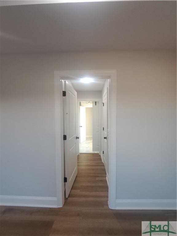 corridor with dark wood-type flooring