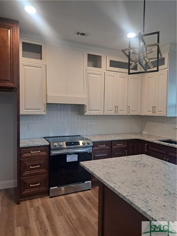 kitchen featuring dark brown cabinetry, dark hardwood / wood-style floors, white cabinetry, and electric stove