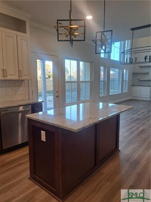 kitchen featuring hanging light fixtures, stainless steel dishwasher, dark hardwood / wood-style floors, tasteful backsplash, and a notable chandelier