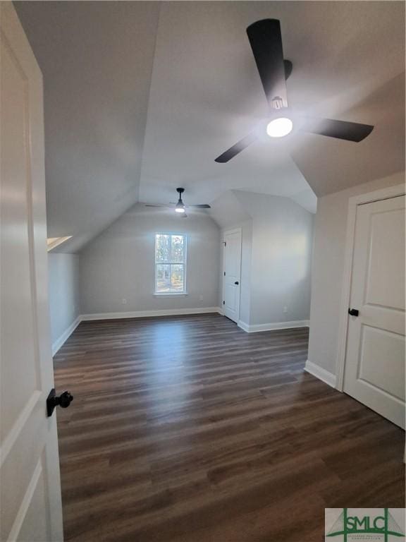 bonus room with vaulted ceiling, ceiling fan, and dark wood-type flooring