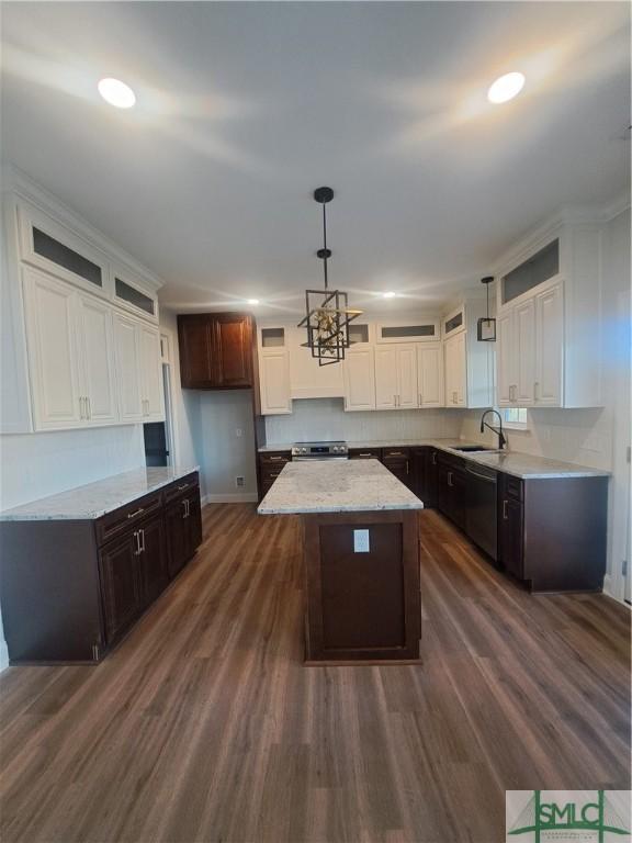 kitchen featuring dark brown cabinets, a kitchen island, dark hardwood / wood-style floors, and appliances with stainless steel finishes