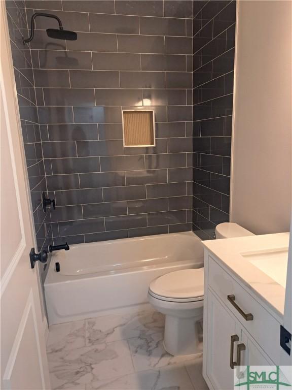 full bathroom with vanity, toilet, and tiled shower / bath