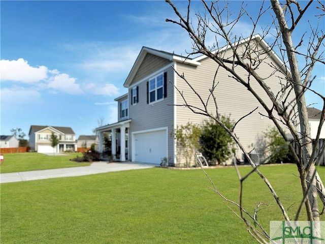 view of side of property featuring concrete driveway, a yard, and an attached garage