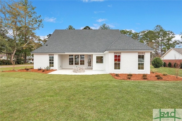 back of house with a patio area and a yard