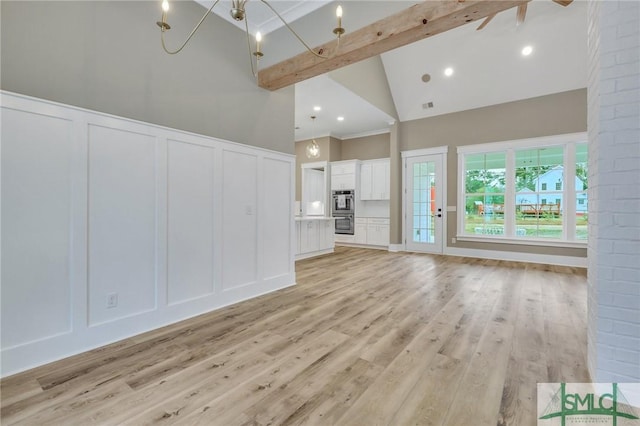 unfurnished living room featuring beam ceiling, light hardwood / wood-style flooring, high vaulted ceiling, and ceiling fan