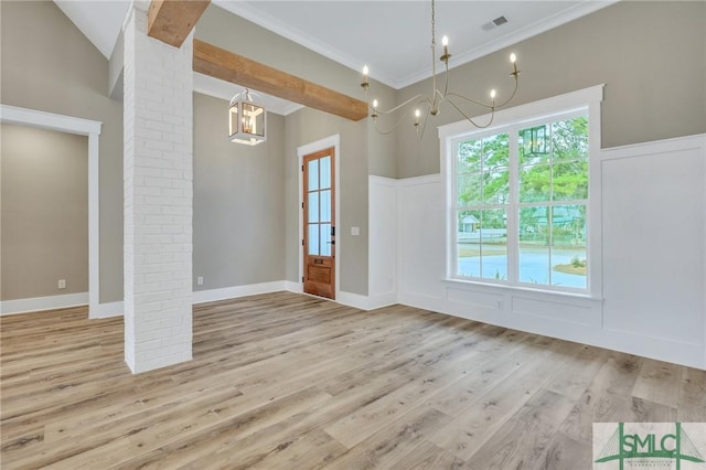 interior space with light wood-type flooring, decorative columns, and ornamental molding