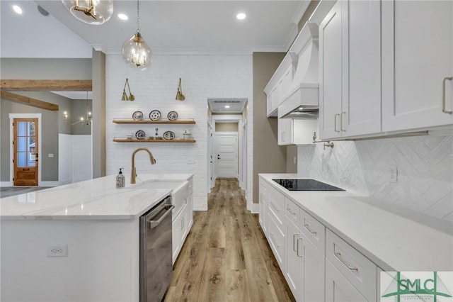 kitchen featuring pendant lighting, white cabinets, stainless steel dishwasher, light stone countertops, and tasteful backsplash