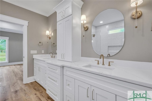 bathroom with a shower, wood-type flooring, and vanity