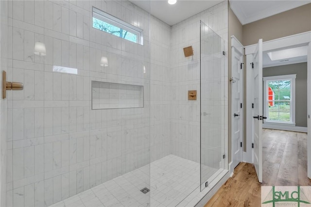 bathroom with hardwood / wood-style floors and a shower with shower door