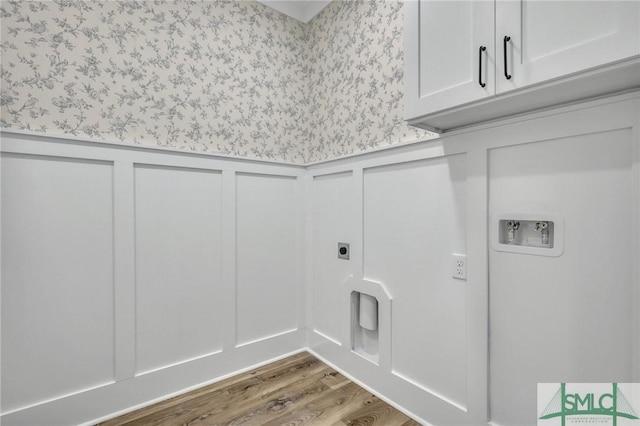 laundry area with washer hookup, electric dryer hookup, cabinets, and wood-type flooring