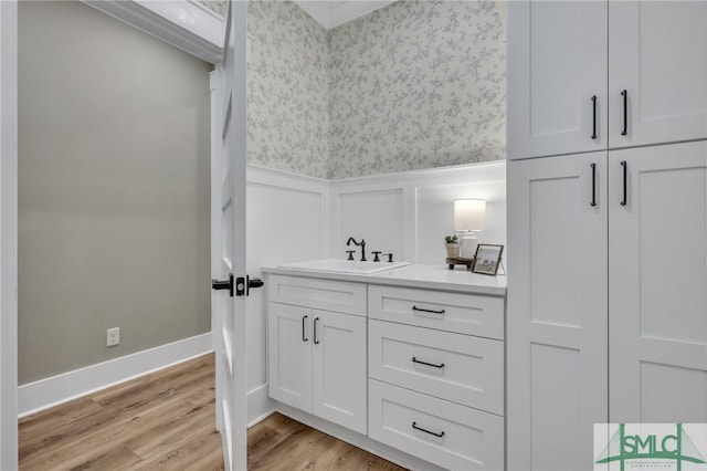 bathroom with hardwood / wood-style floors and vanity