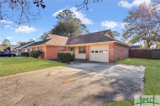 view of front of home with a front yard and a garage