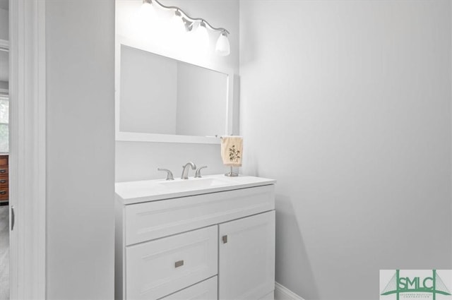 bathroom with vanity and baseboards