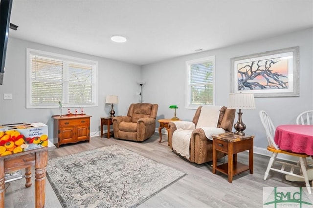 living area with light wood finished floors and baseboards