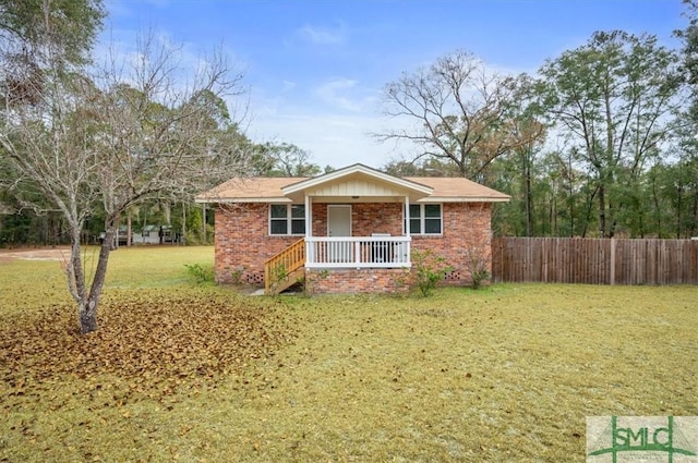 single story home featuring a porch and a front yard