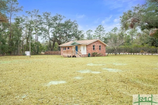 ranch-style home with a front yard and brick siding