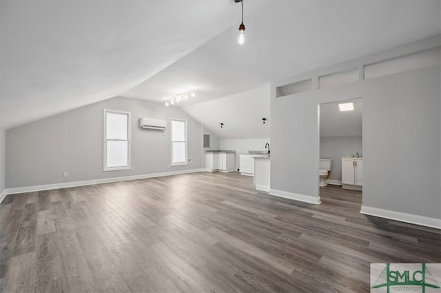 bonus room with dark wood-type flooring, a wall mounted AC, and baseboards