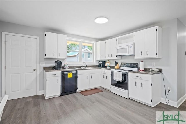 kitchen featuring dark countertops, white appliances, and white cabinetry