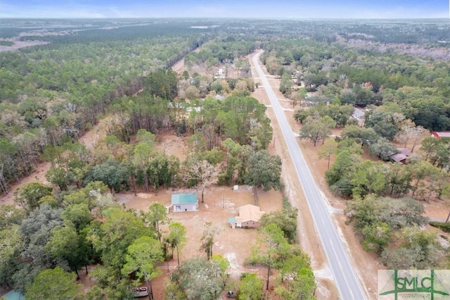 drone / aerial view with a wooded view