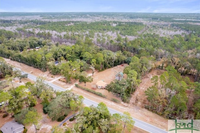 aerial view featuring a wooded view