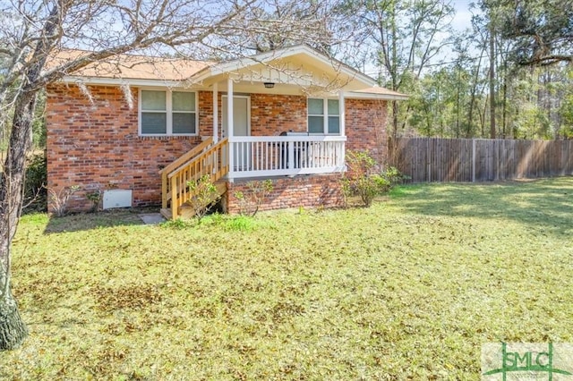 ranch-style home with stairs, brick siding, a front lawn, and fence