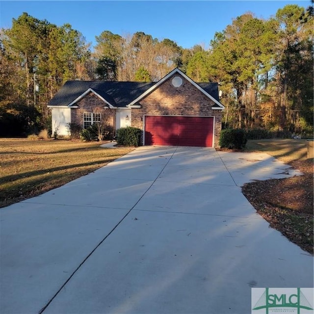 view of front of home with a front lawn and a garage