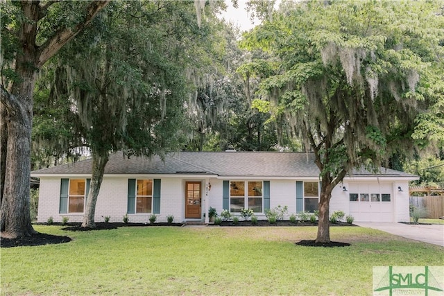 ranch-style house with a garage and a front lawn