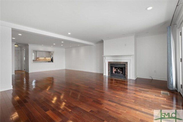 unfurnished living room with dark hardwood / wood-style floors