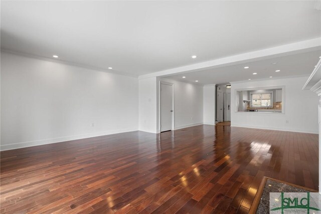 unfurnished living room with dark wood-type flooring