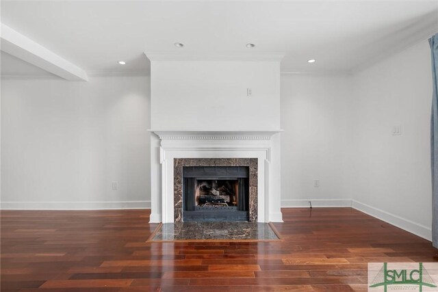 unfurnished living room featuring crown molding, dark wood-type flooring, and a high end fireplace