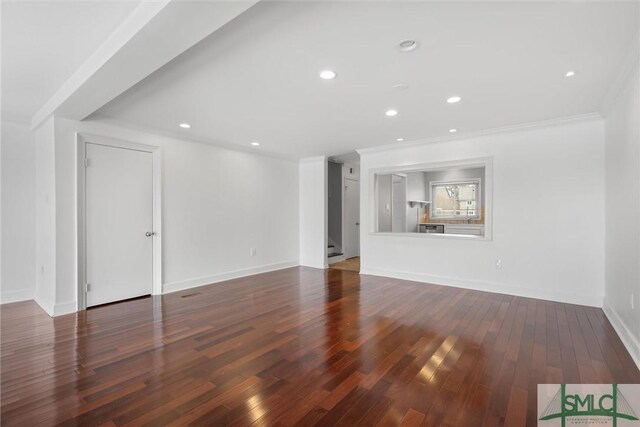 unfurnished living room with dark hardwood / wood-style floors and ornamental molding