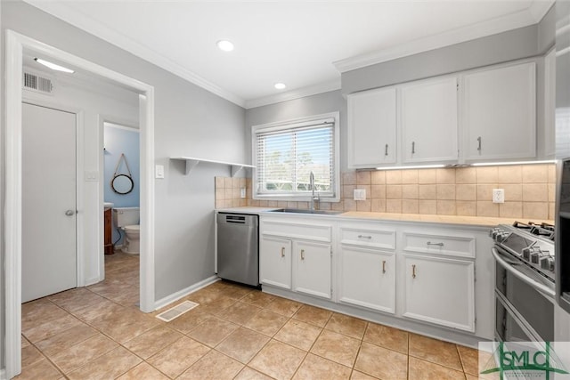 kitchen with white cabinets, decorative backsplash, stainless steel appliances, and sink