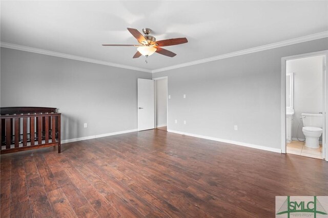 unfurnished bedroom featuring ensuite bathroom, ceiling fan, ornamental molding, and dark hardwood / wood-style floors