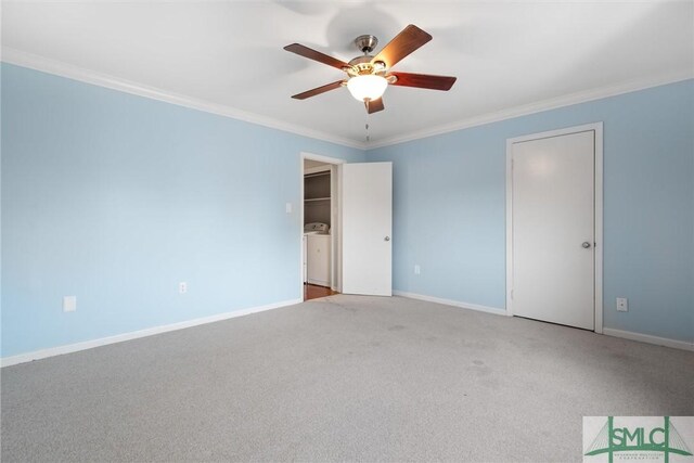 carpeted empty room featuring washer / clothes dryer, crown molding, and ceiling fan