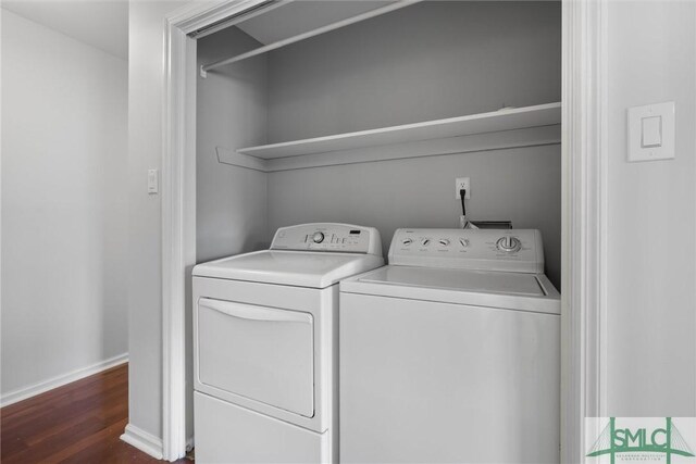 washroom with dark wood-type flooring and washing machine and clothes dryer