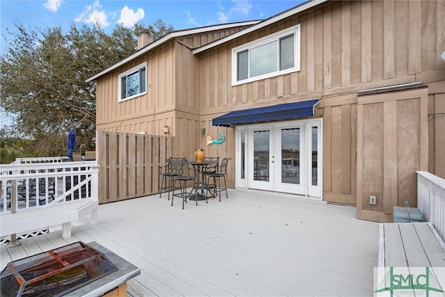 rear view of property with a wooden deck and french doors