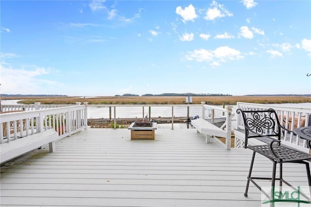 wooden deck with an outdoor fire pit