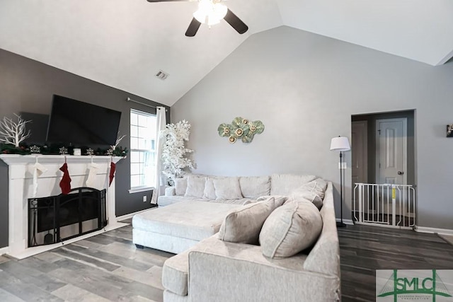 living room featuring hardwood / wood-style flooring, high vaulted ceiling, and ceiling fan