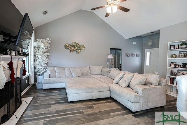 living room featuring ceiling fan, dark hardwood / wood-style floors, and high vaulted ceiling