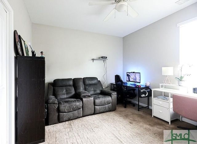 carpeted office space with ceiling fan