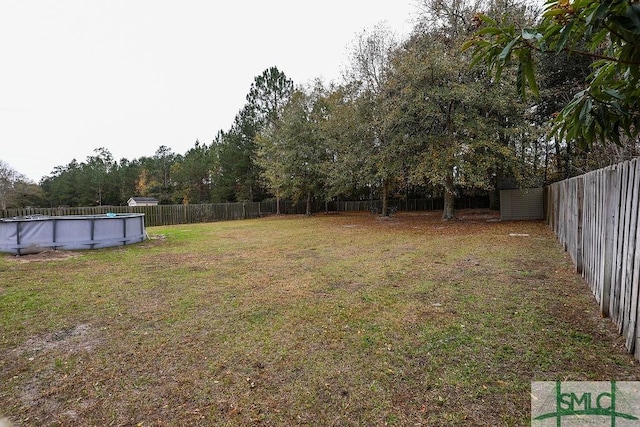 view of yard with a fenced in pool