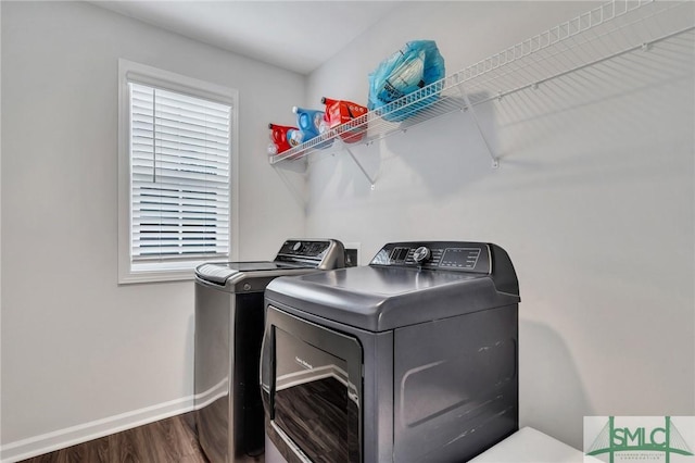 laundry area featuring wood-type flooring and washing machine and dryer