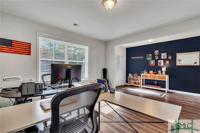 office space with wood-type flooring