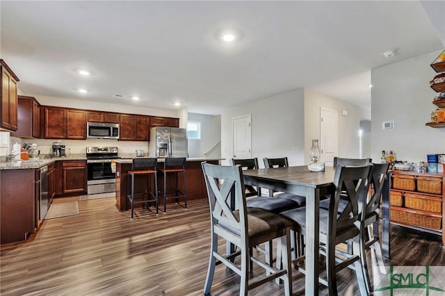 dining space featuring dark hardwood / wood-style floors