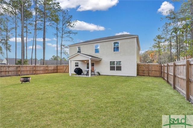 rear view of property featuring a yard and a patio