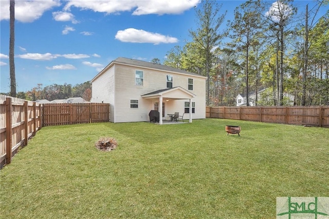 back of house featuring a yard and a patio