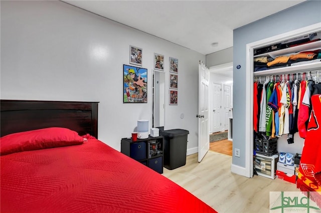 bedroom with wood-type flooring and a closet